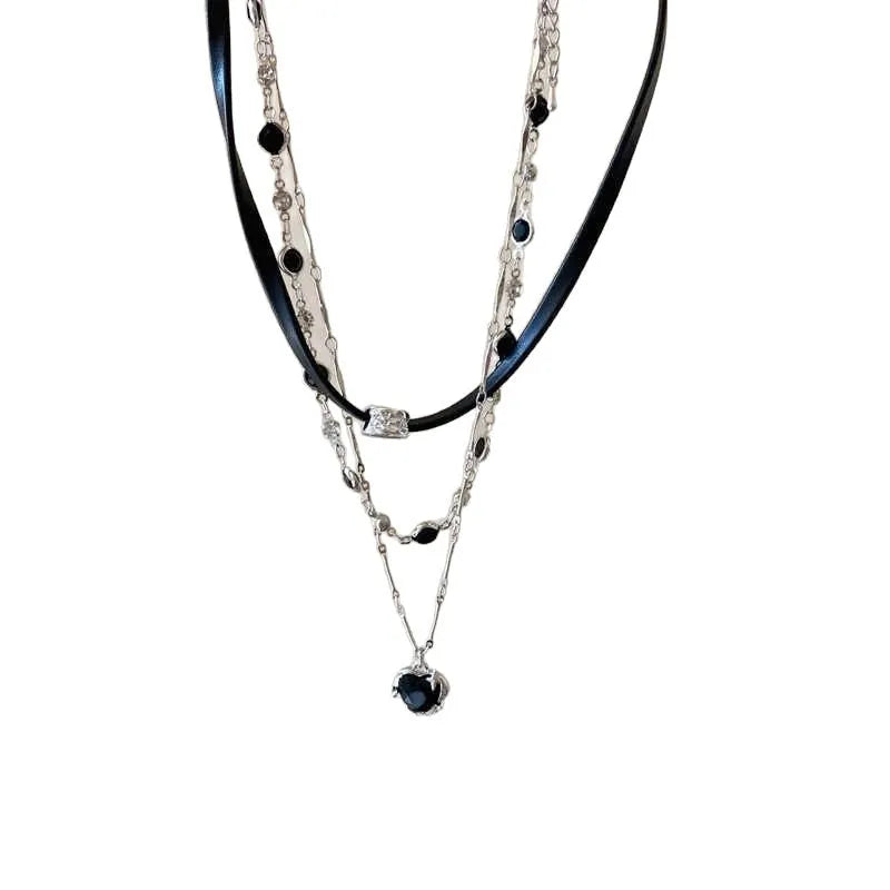 Women's creative necklace set showing a double-layer leather heart necklace and a single crystal heart pendant on a metal chain.