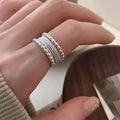 Copper alloy geometric ring with woven twisted multilayer design and adjustable opening