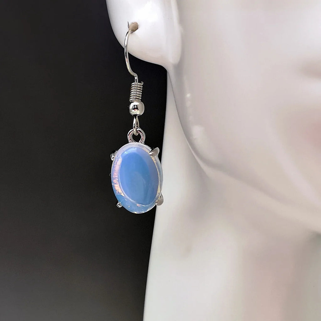Moonlight white opal earrings with cross shaped drop design and retro moonstone appearance