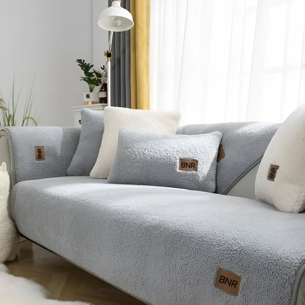 Lambswool sofa slipcover in blue on a three-seater sofa with matching cushion cover.