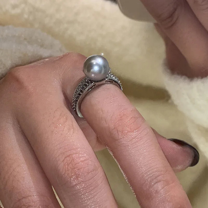 Women's adjustable open ring with geometric design and black pearl finish on copper.