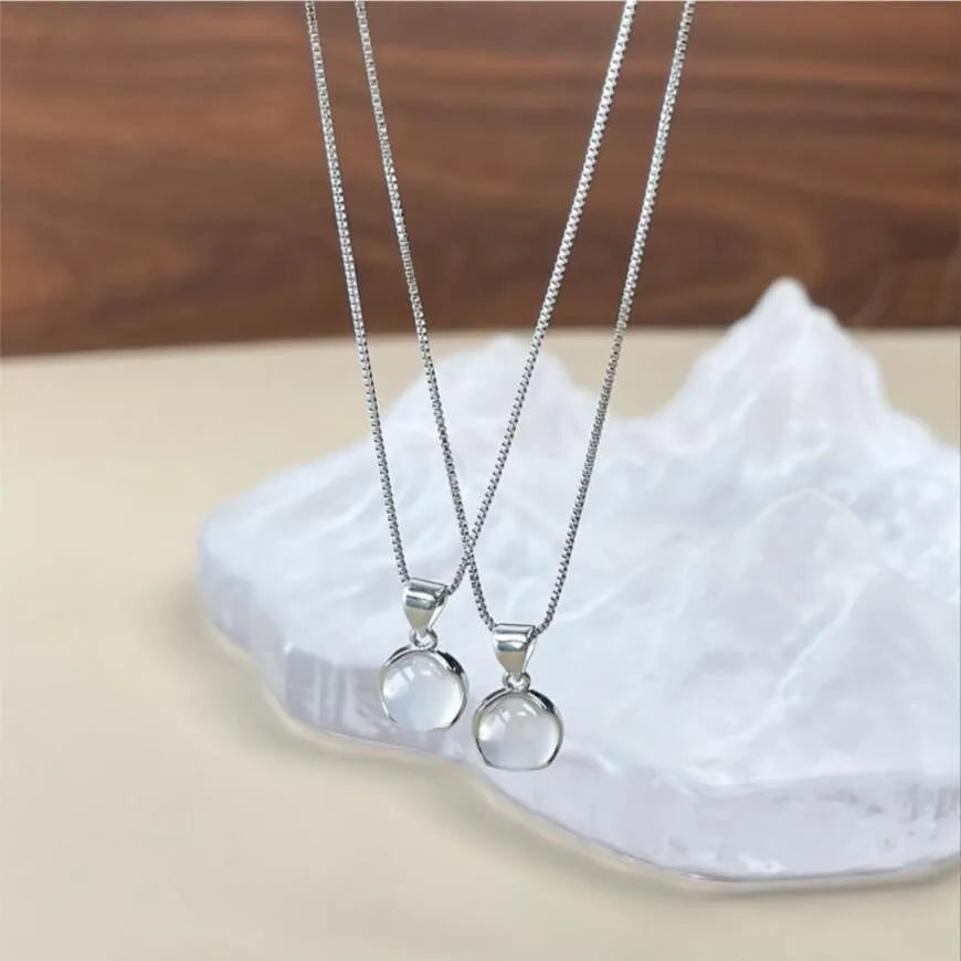 Women's oval artificial crystal pendant necklace with eight-point star design on an adjustable box chain.
