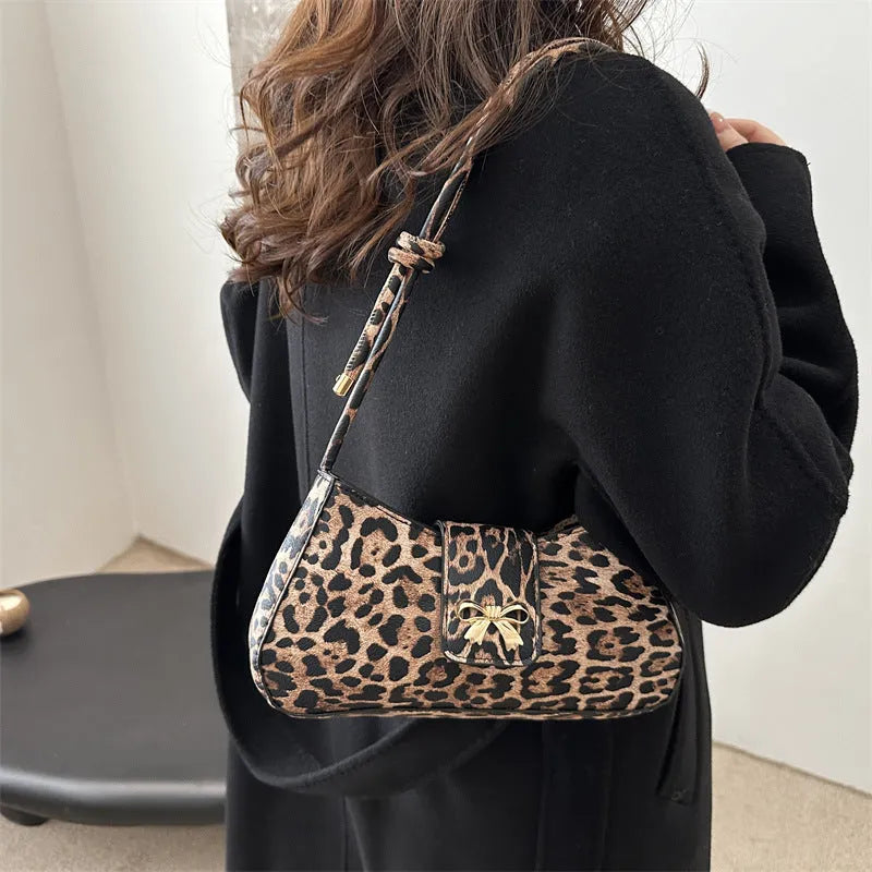 Casual women's PU handbag with sandwich pocket organisation in black colour showing 27 cm width