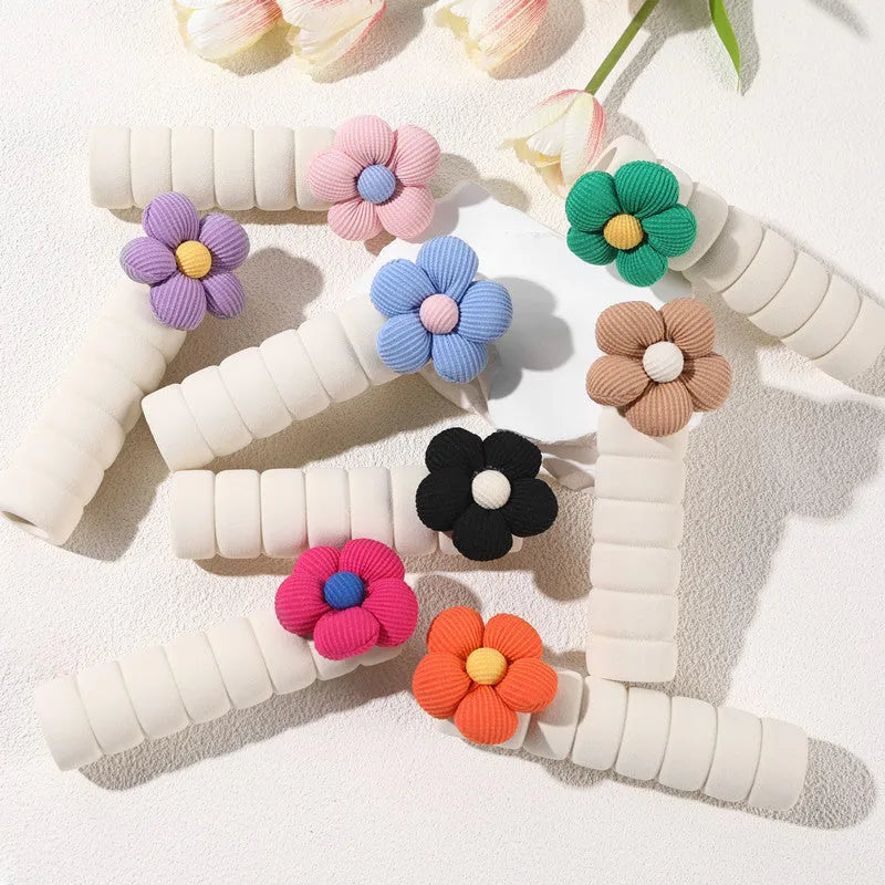 Flower pattern soft PEVA door handle protective cover on a round door knob.
