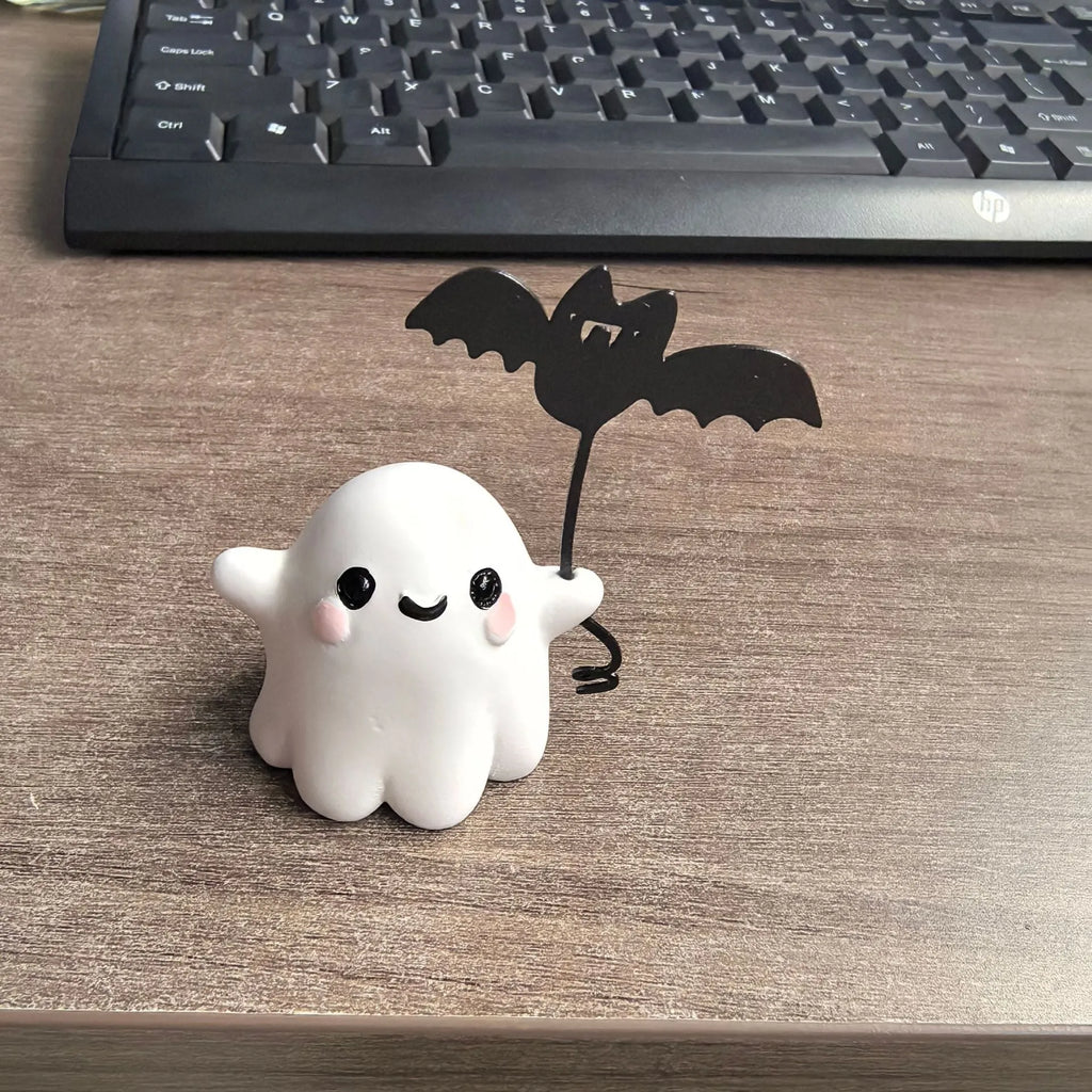 Small resin statue of a ghost dog with a bat, a miniature Halloween ornament.