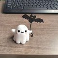 Small resin statue of a ghost dog with a bat, a miniature Halloween ornament.
