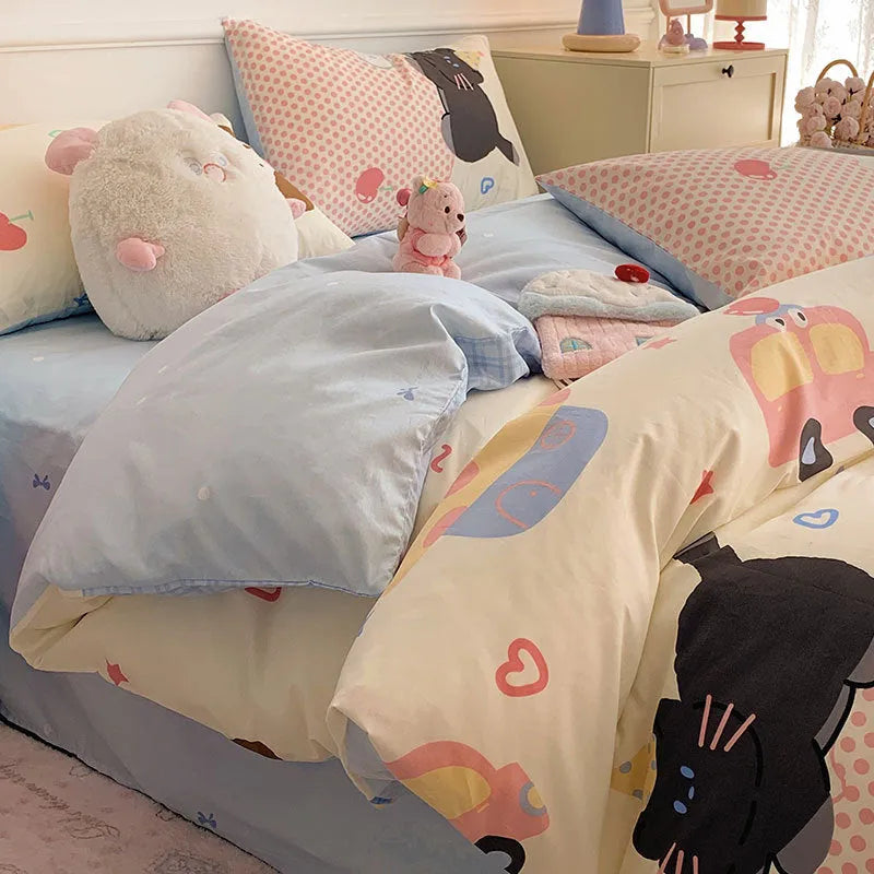 Cartoon dog patterned cotton four-piece bedding set laid on a bed.