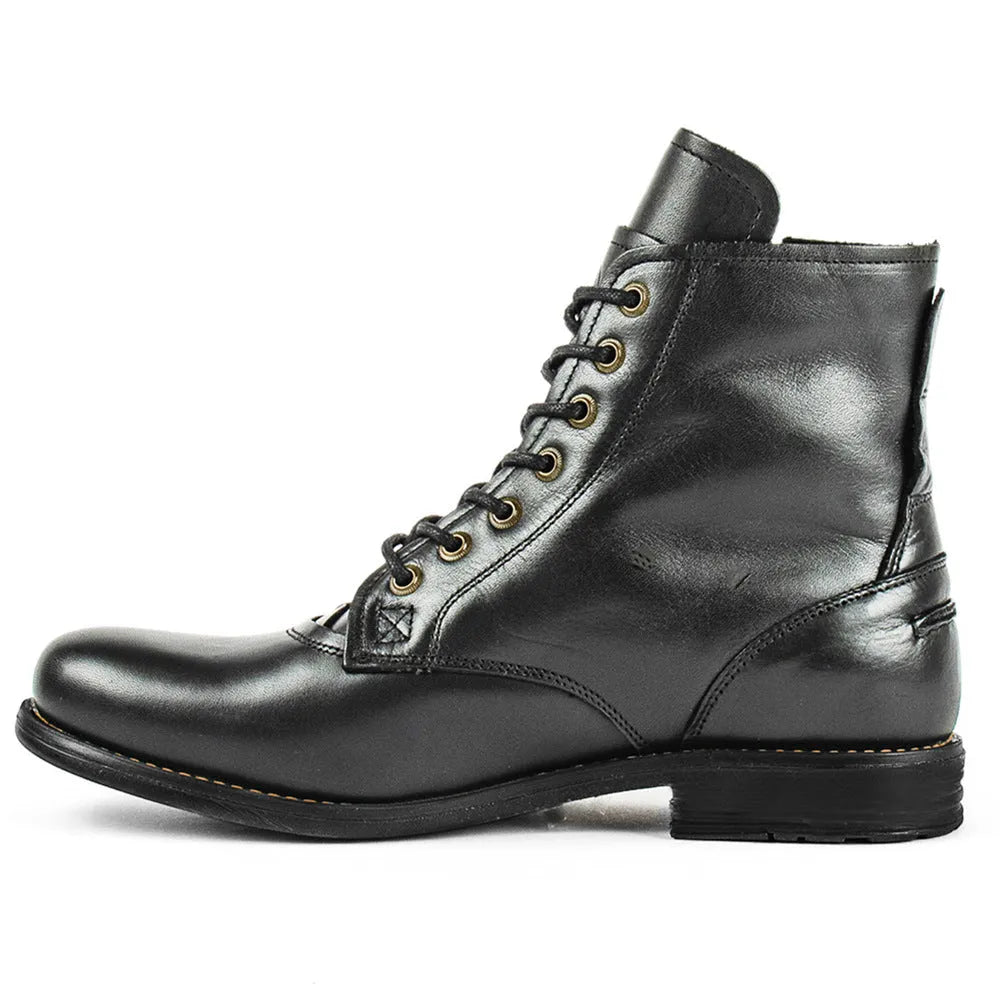 Black and brown two-tone leather ankle boots with side zipper and low heel.