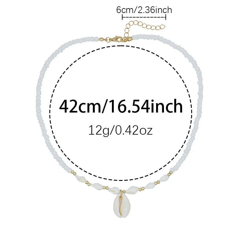 White necklace with a conch shell pendant made from Mother Pearl shellfish on an electroplated chain.