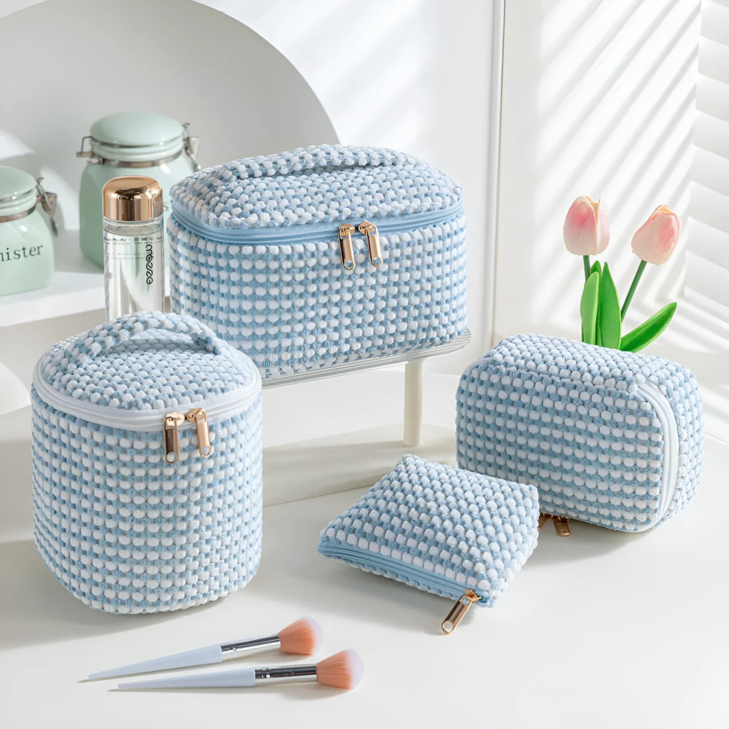 Four cube-shaped flannelette makeup bags in different colours including pink, khaki, pink dots, and blue with dots