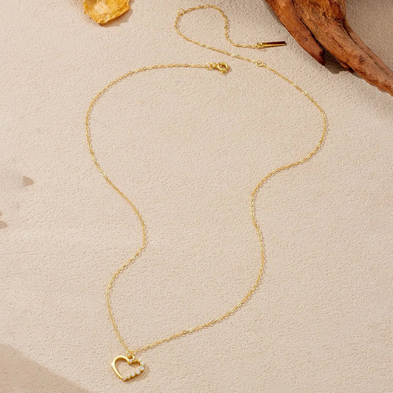 S925 sterling silver hollow heart pendant necklace on a regular chain, shown in gold and platinum colour options.