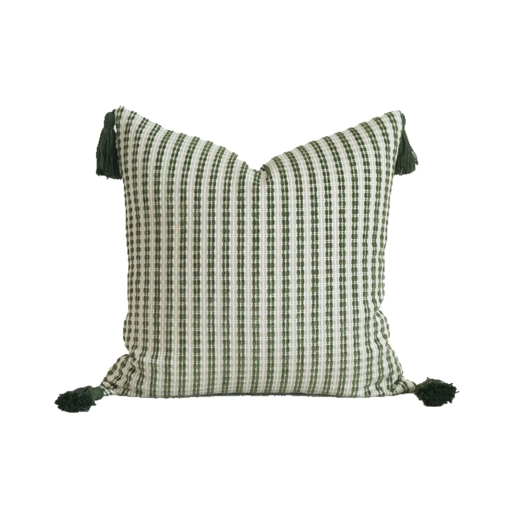Green striped and botanical pattern decorative pillow set with tassel detail for hotel sample rooms.
