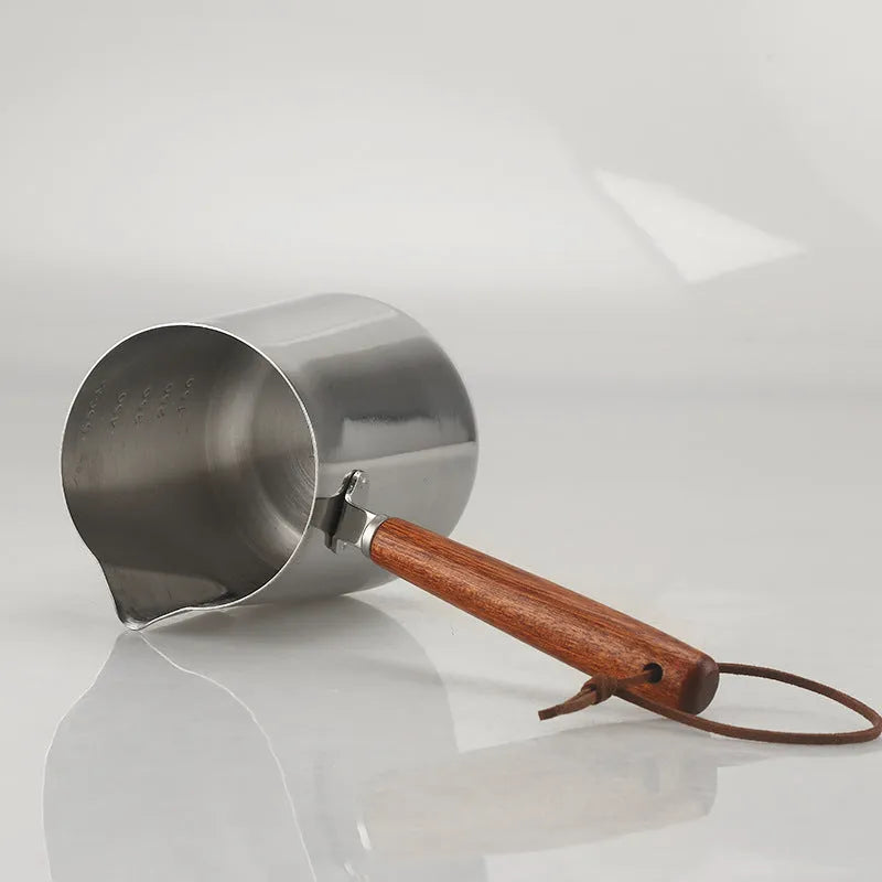 Stainless steel coffee cup with measurement scale markings and wooden handle shown in solid colour