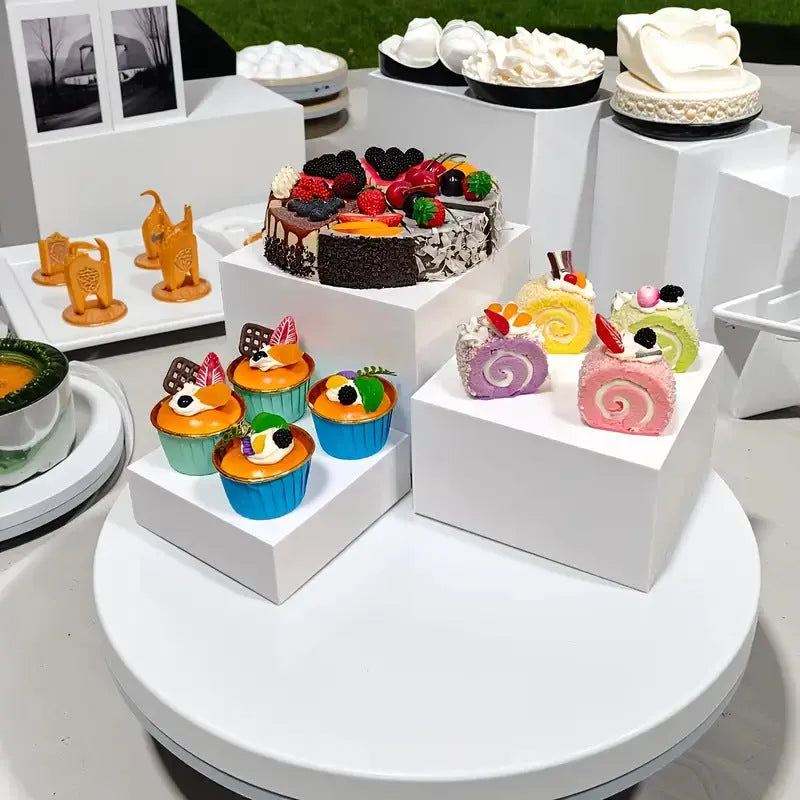 White plastic cube dessert display stand with six modular stacking components for cake presentation