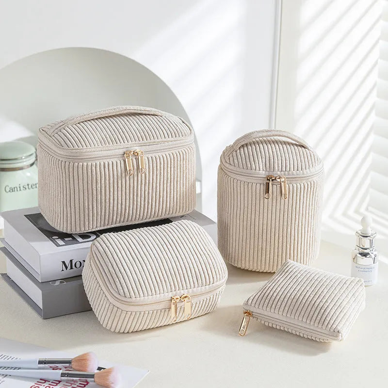 Four cube-shaped flannelette makeup bags in different colours including pink, khaki, pink dots, and blue with dots