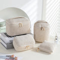 Four cube-shaped flannelette makeup bags in different colours including pink, khaki, pink dots, and blue with dots