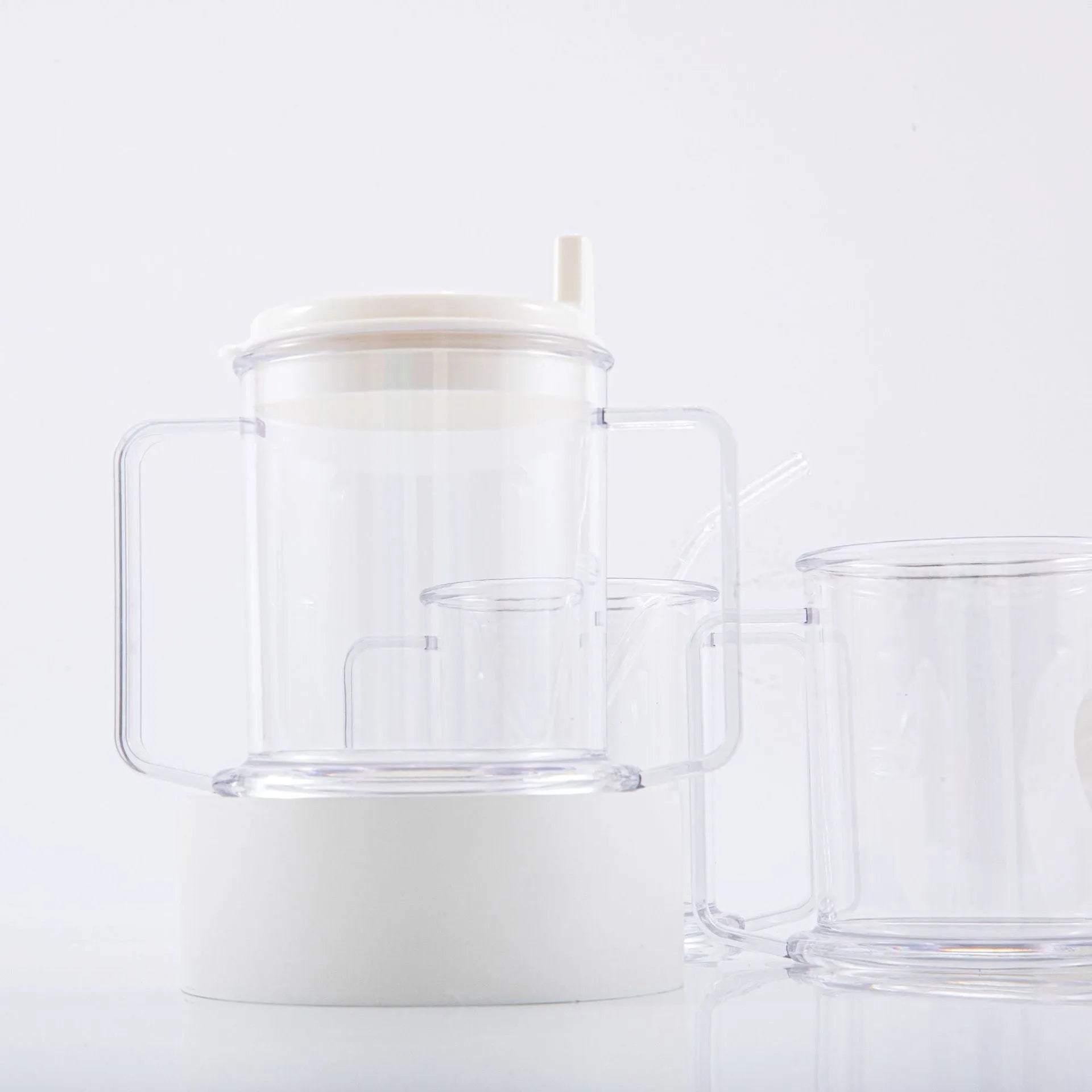 Transparent plastic drinking cup with spill-proof lid showing 14cm height and 12cm diameter dimensions