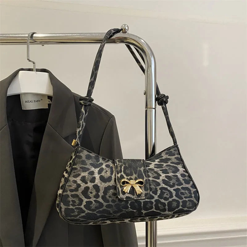 Casual women's PU handbag with sandwich pocket organisation in black colour showing 27 cm width