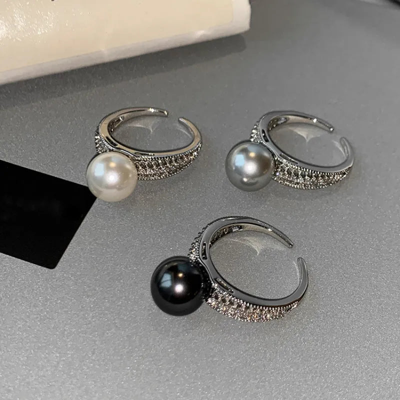 Women's adjustable open ring with geometric design and black pearl finish on copper.