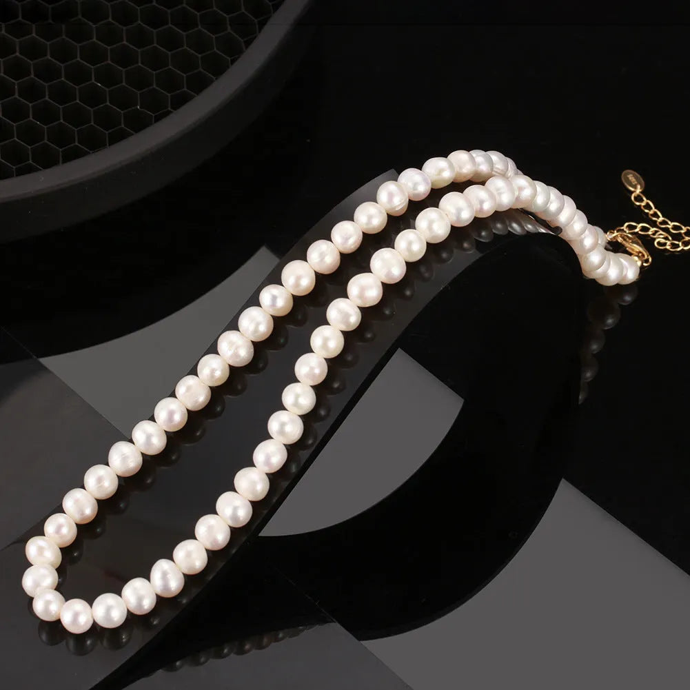 Women's simple adjustable necklace with natural freshwater pearls on a sterling silver chain.