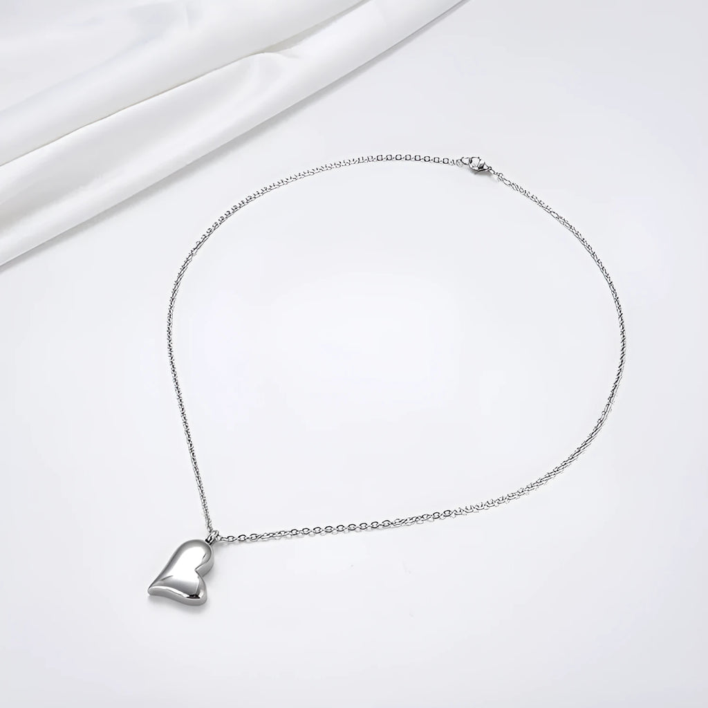 Silver curved peach heart pendant on stainless steel chain with extension