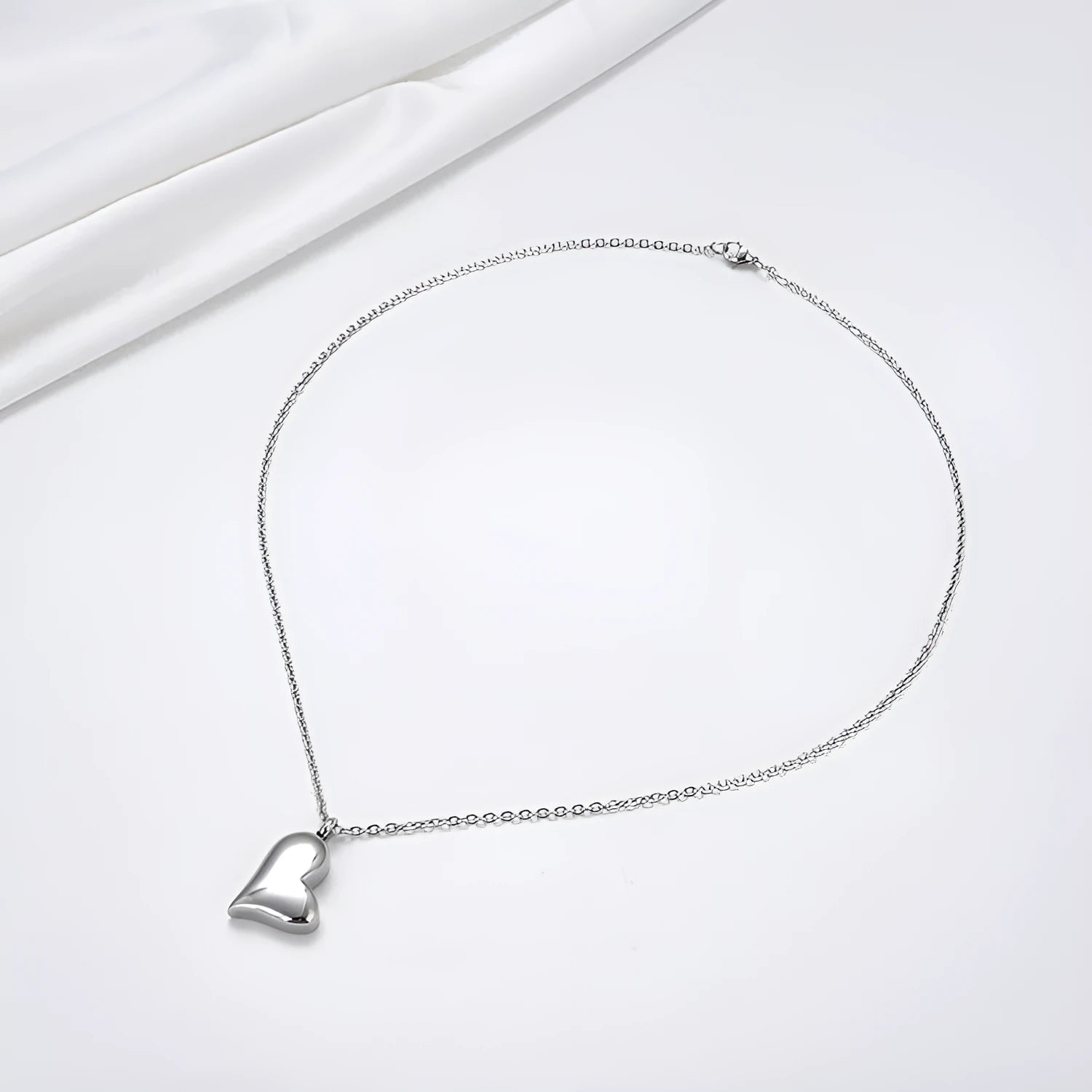 Silver curved peach heart pendant on stainless steel chain with extension
