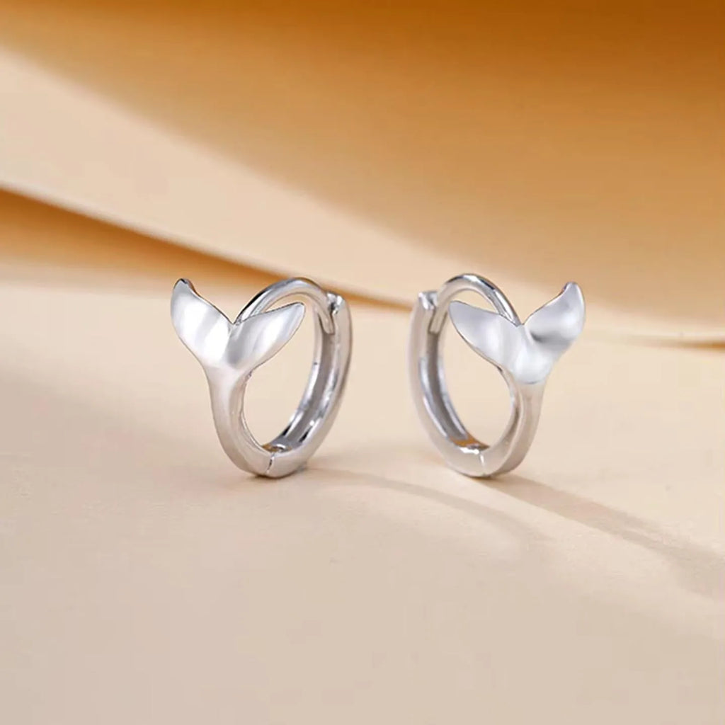 Women's copper fishtail design earrings in white gold or yellow gold colour.