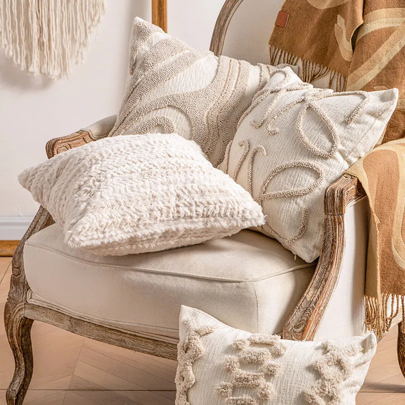 Knitted striped cushion cover with tassel detail in spiral dots design, shown in 45x45cm size.