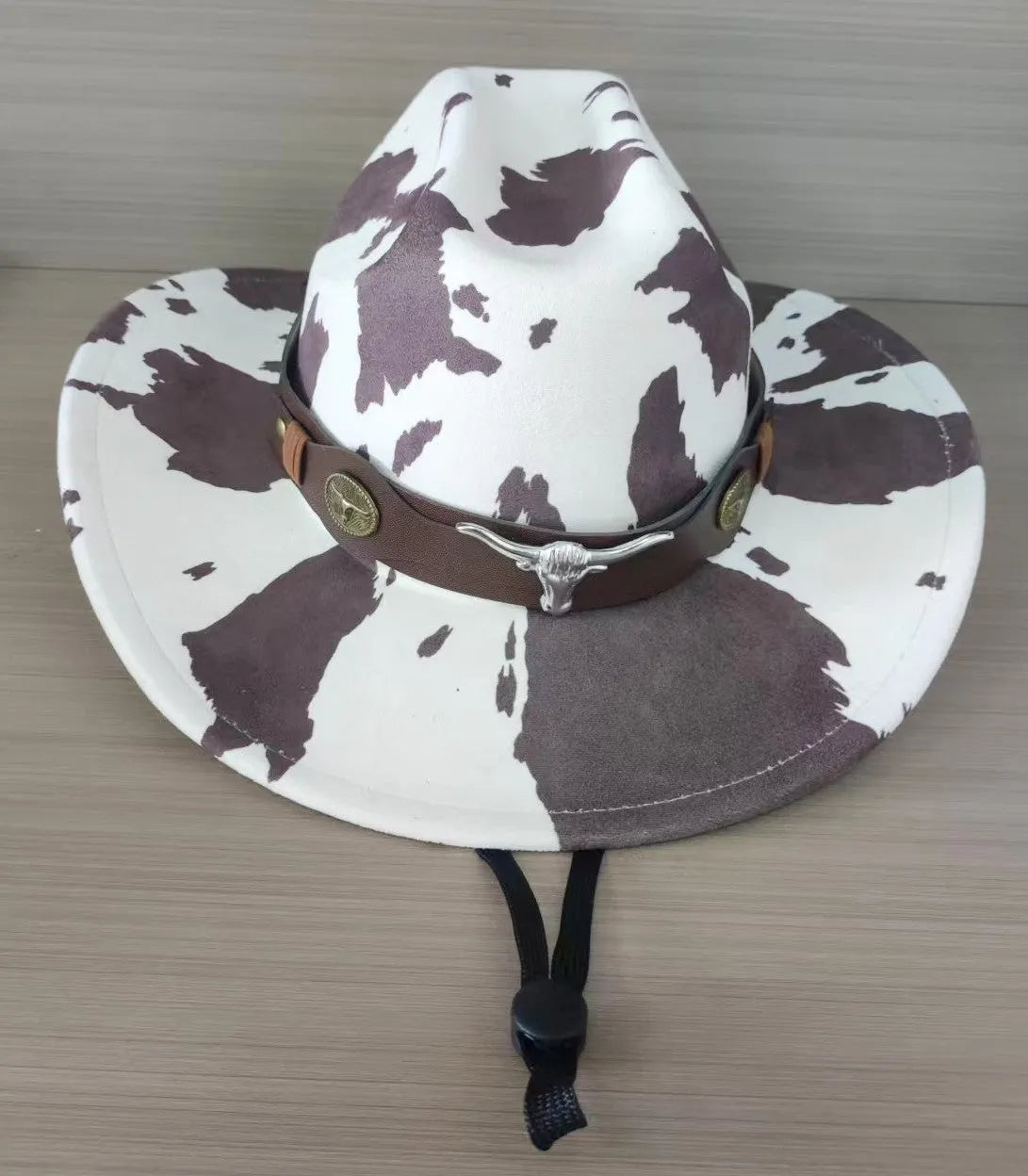 Brown leather velvet curved-edge western cowboy hat with a conical crown on a plain background.