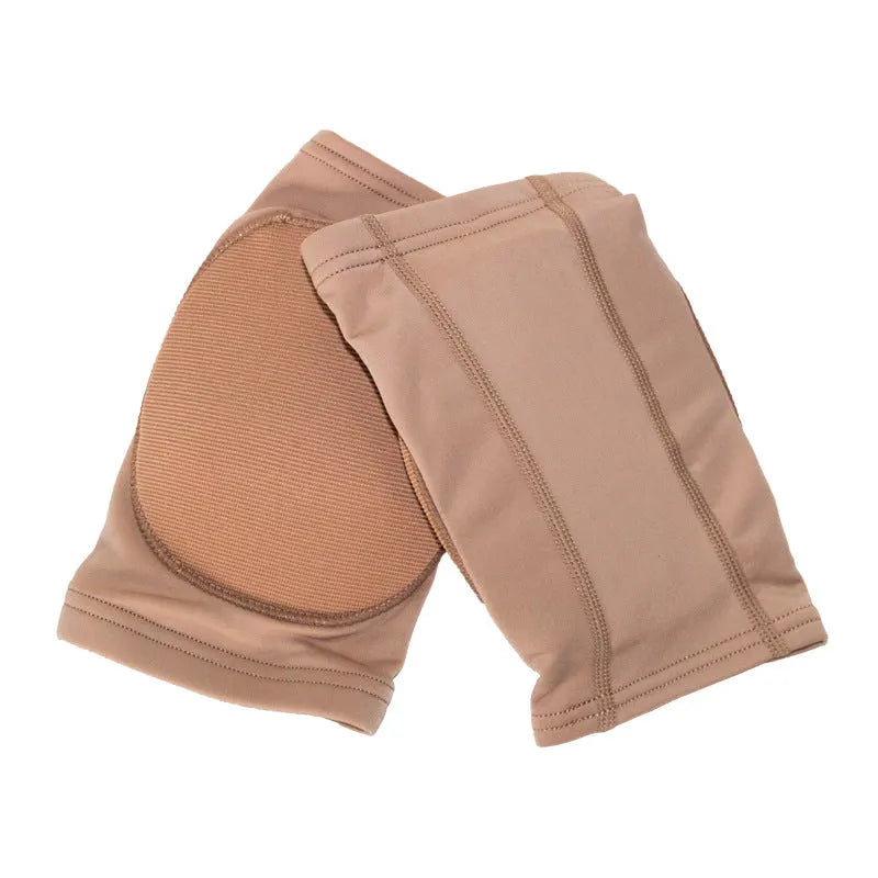 A pair of skin-colour ballet dance knee pads with elastic straps, shown laid flat.
