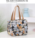 Women's portable square canvas bag with aluminium handle in a choice of printed designs including flowers and cats.