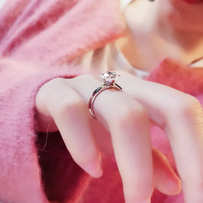 White gold plated zircon ring with six-claw setting and geometric shape on finger