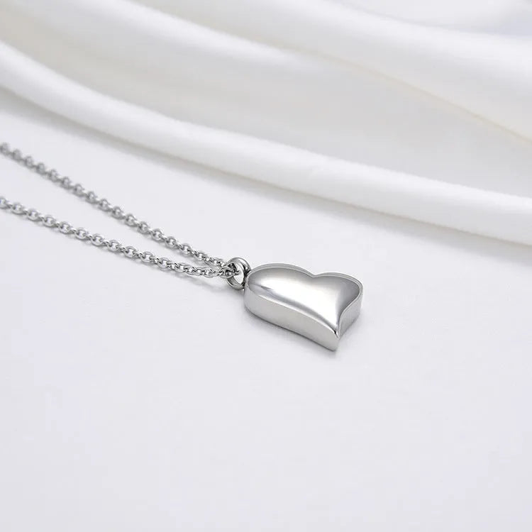 Silver curved peach heart pendant on stainless steel chain with extension