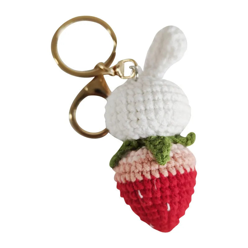 Hand-woven white wire pendant with rabbit strawberry cartoon design and key attachment