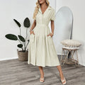 Light green lapel shirt dress with waist-tight skirt and pocket for office wear.