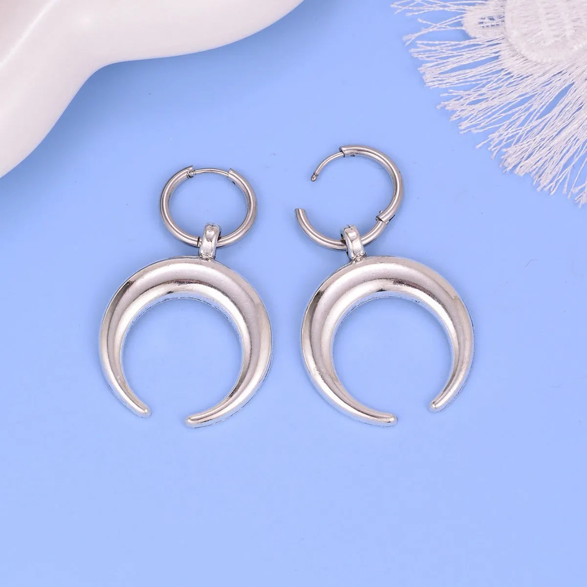 Silver geometric hoop earrings with moon design showing Gothic vintage style