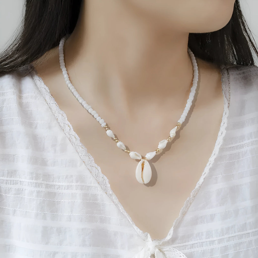 White necklace with a conch shell pendant made from Mother Pearl shellfish on an electroplated chain.