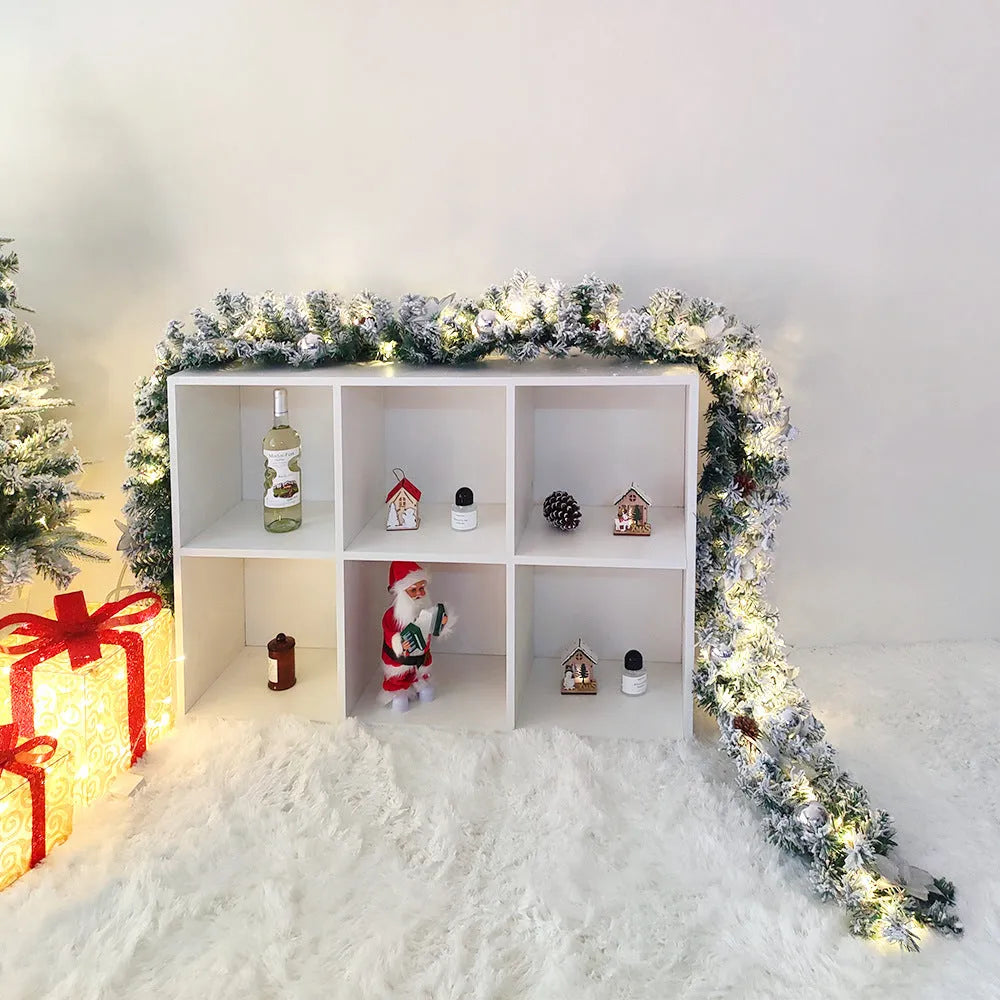PVC Christmas rattan garland with flocked finish in golden colour option draped over mantelpiece