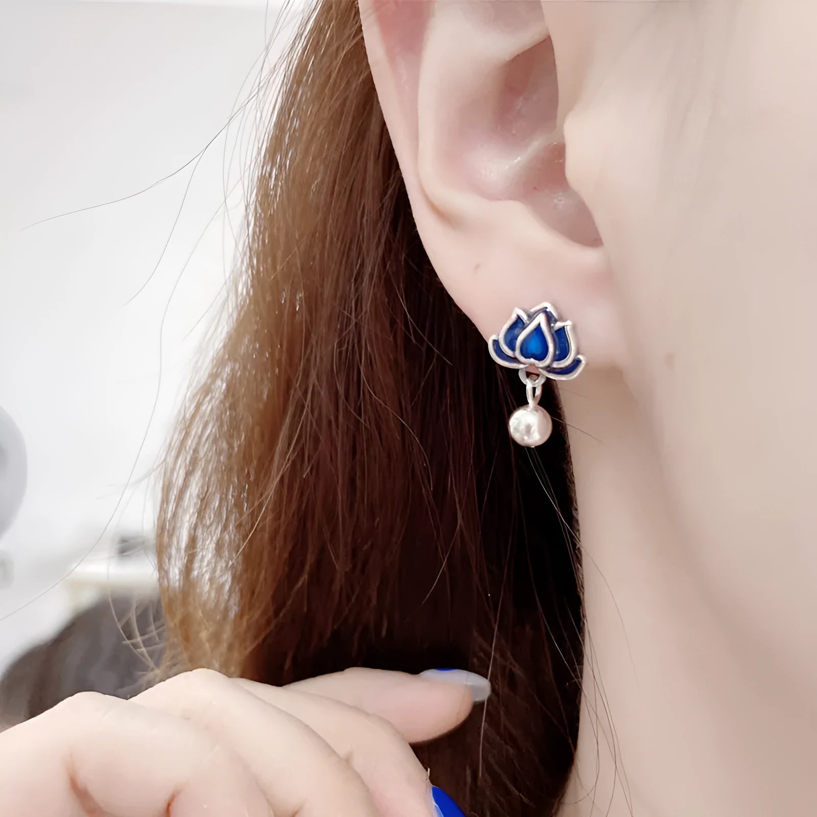 Blue Lotus earrings with a flower stud and dangling seedpod tassel in silver-tone alloy.