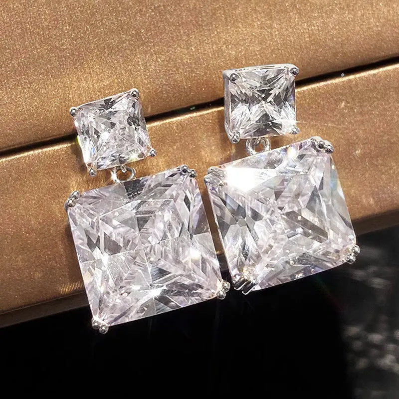 A pair of geometric square-shaped copper earrings for women, shown in gold and white gold colour options.