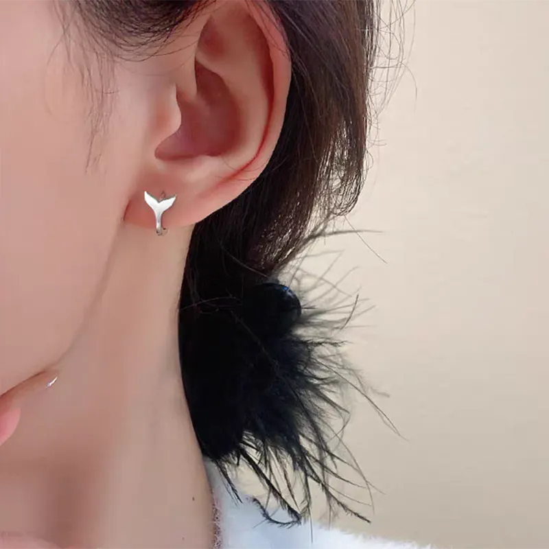 Women's copper fishtail design earrings in white gold or yellow gold colour.