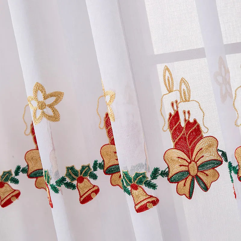 Pair of red and white Christmas curtains with embroidered snowflake design, showing light filtering through.