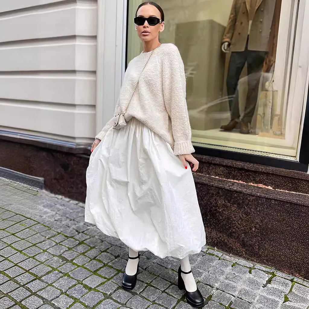 Women's solid colour cotton long skirt on a hanger, available in black or white.