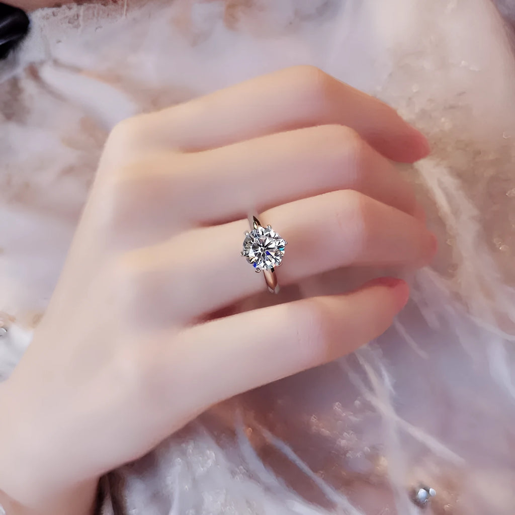 White gold plated zircon ring with six-claw setting and geometric shape on finger