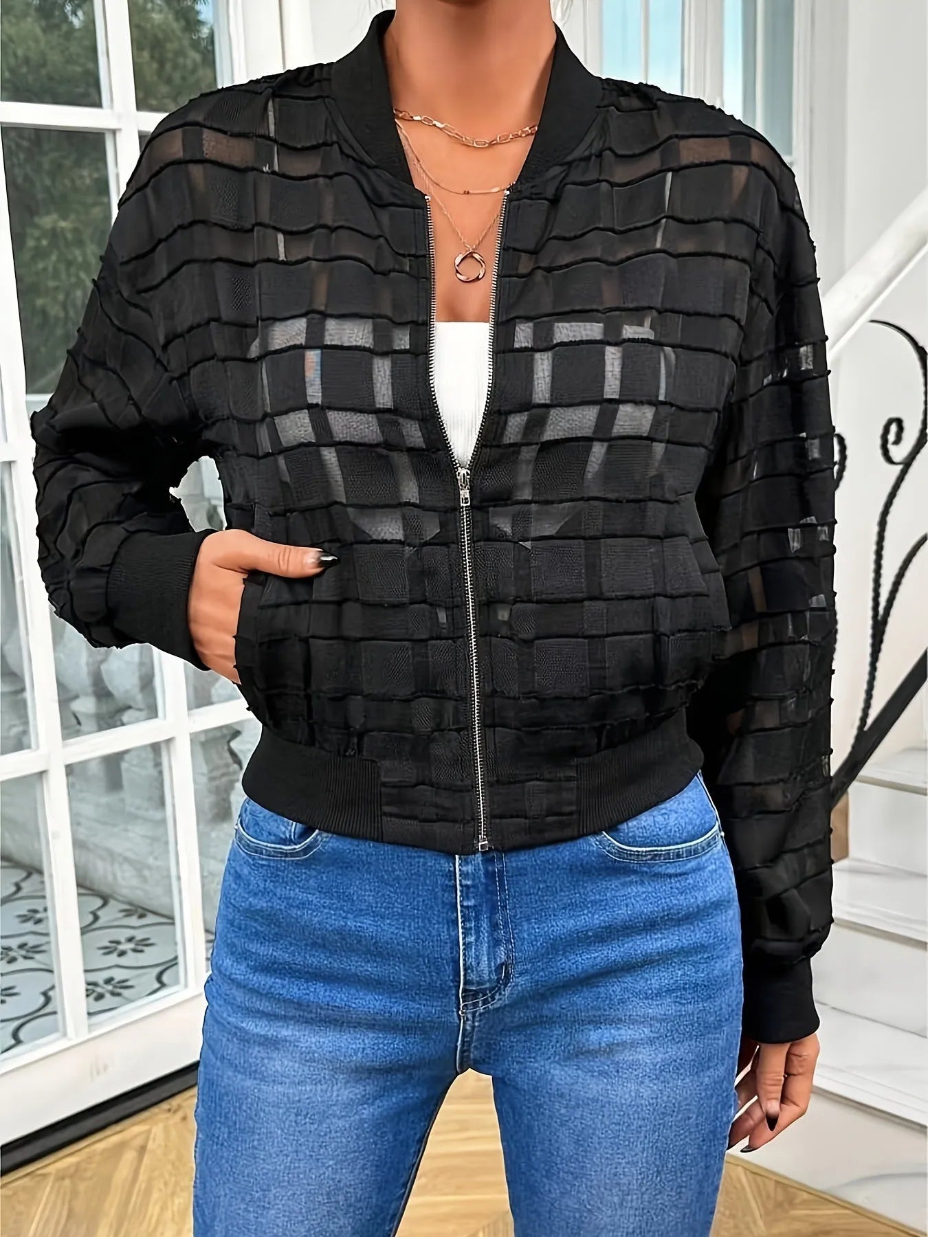 Black women's casual jacket with semi-transparent geometric pattern and zip front.
