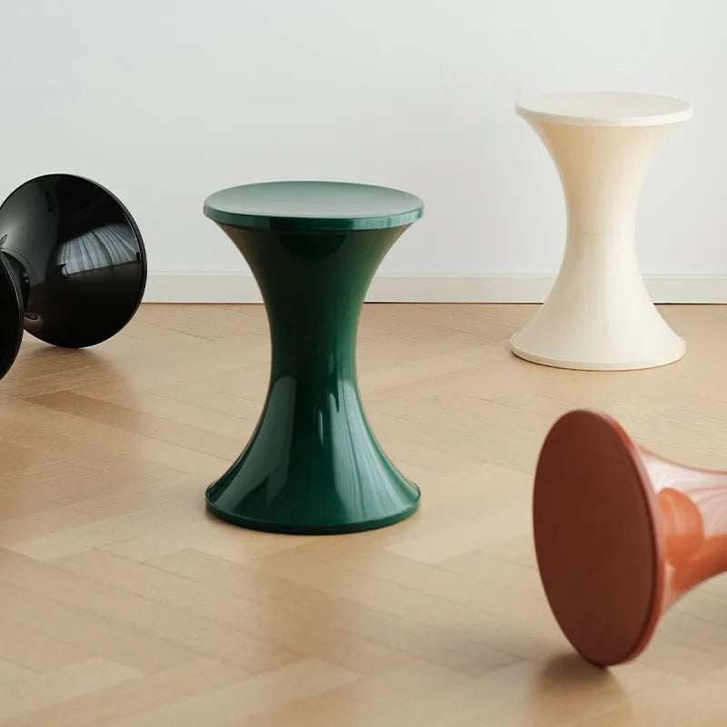 A plastic hourglass-shaped shoe changing stool in a choice of colours.