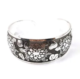 Ethnic carved open Miao silver bracelet showing turtle and elephant motifs