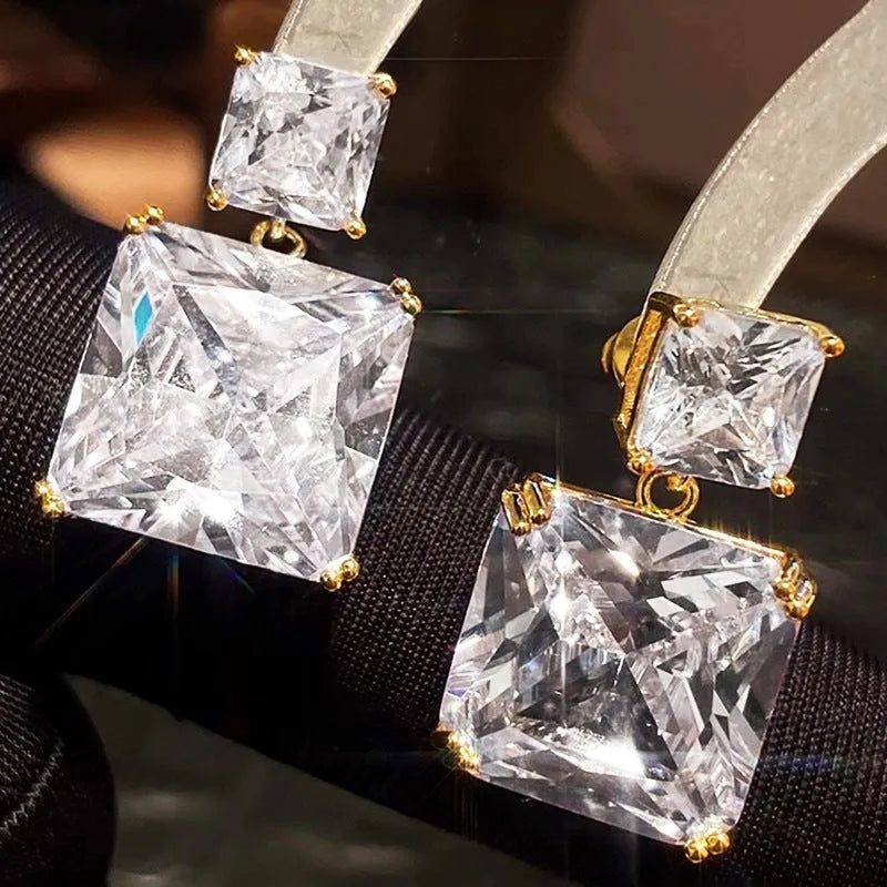 A pair of geometric square-shaped copper earrings for women, shown in gold and white gold colour options.