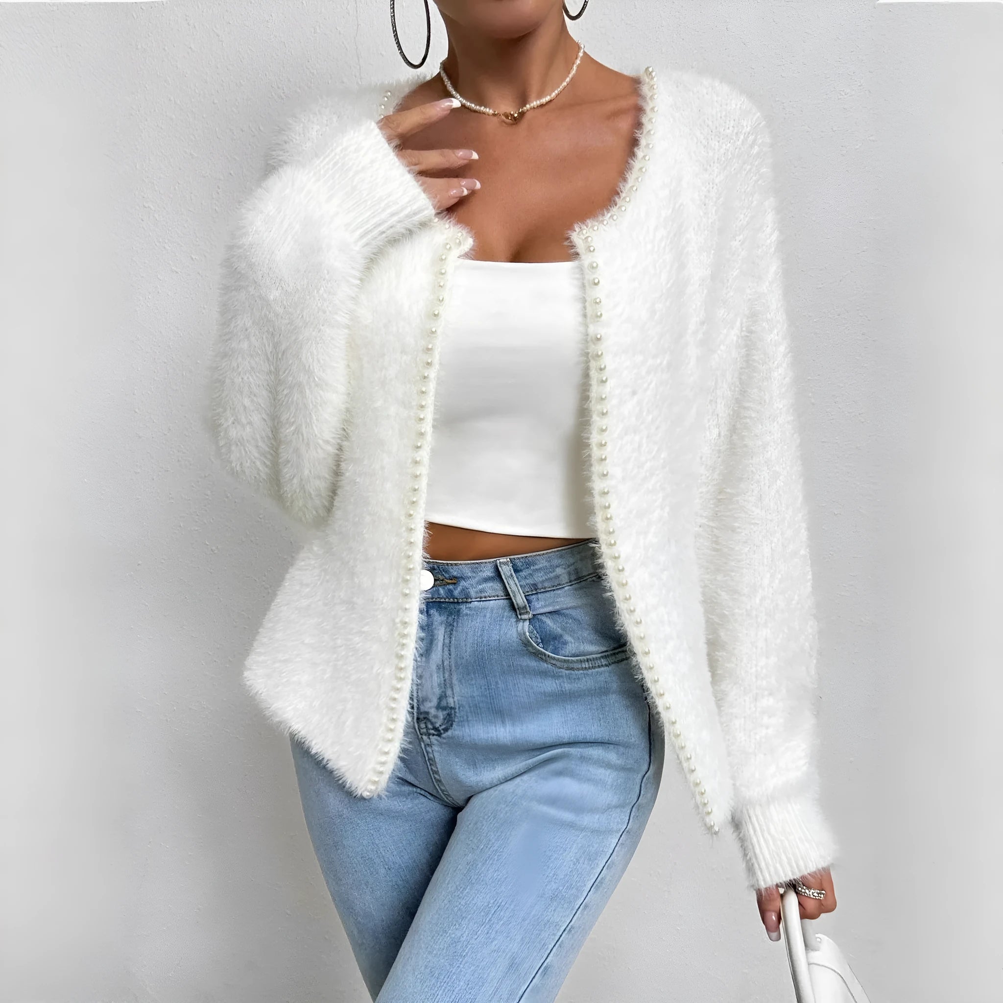 White women's V-neck cardigan sweater made from polyester knit fabric