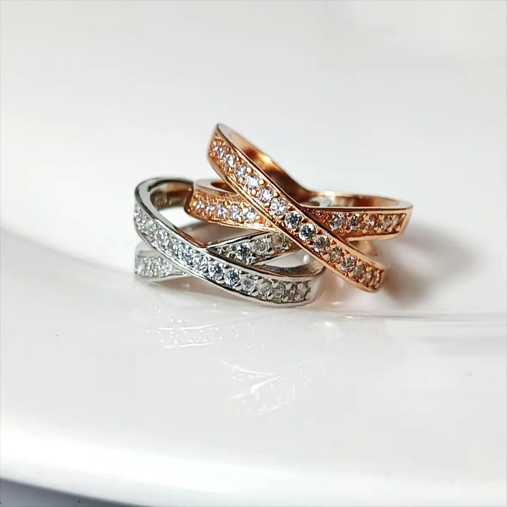 A simple copper ring with a metal cross design featuring micro-inlaid zircon, shown in rose gold and silver tone finishes.